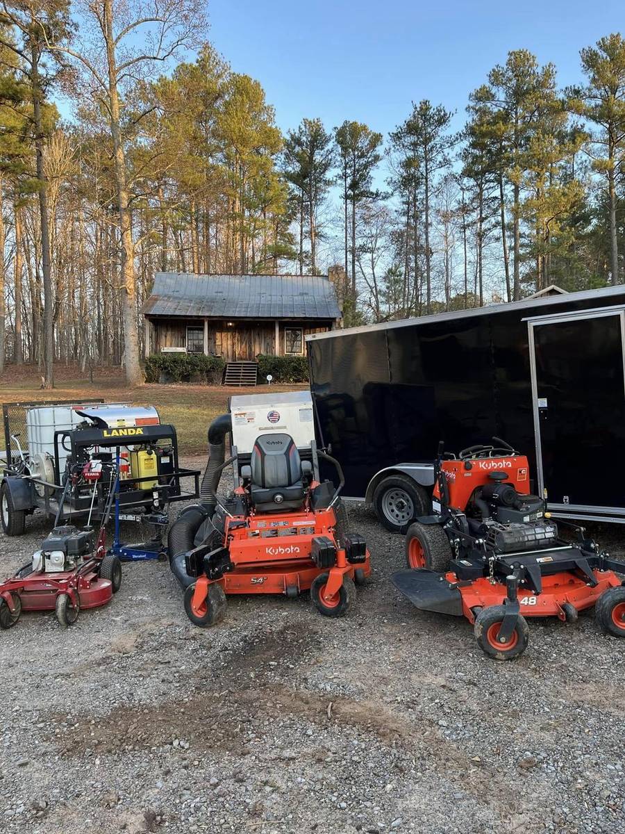 Southern Skies Outdoor Services trailer, mowers and equipment staged for a job in Dallas, Georgia